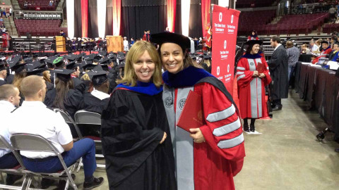 Photo of two graduates
