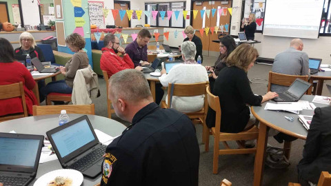 Group of people taking a survey on their laptops